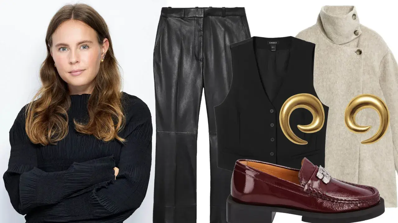 Woman in black top next to VILA leather pants, black vest, beige coat, burgundy loafers, and gold earrings.